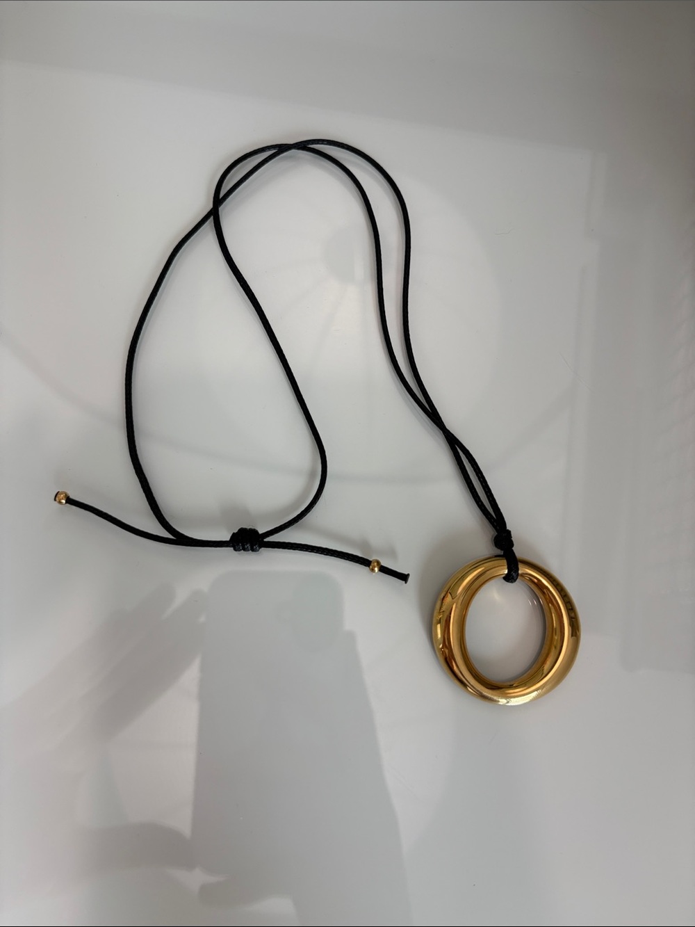 Gold-Tone Circle Pendant Necklace on Black Cord